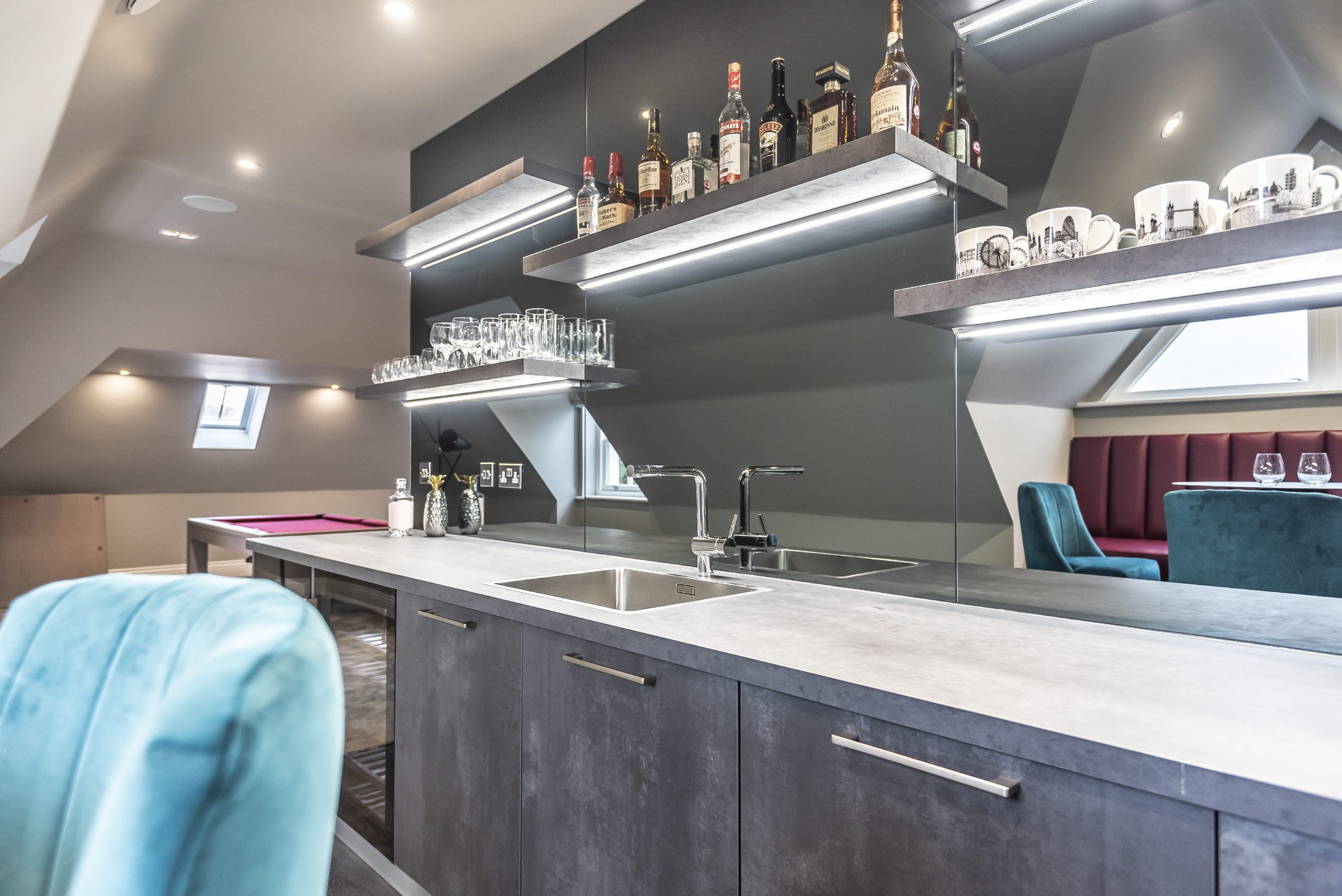 Open shelving with integrated lighting in a home bar area