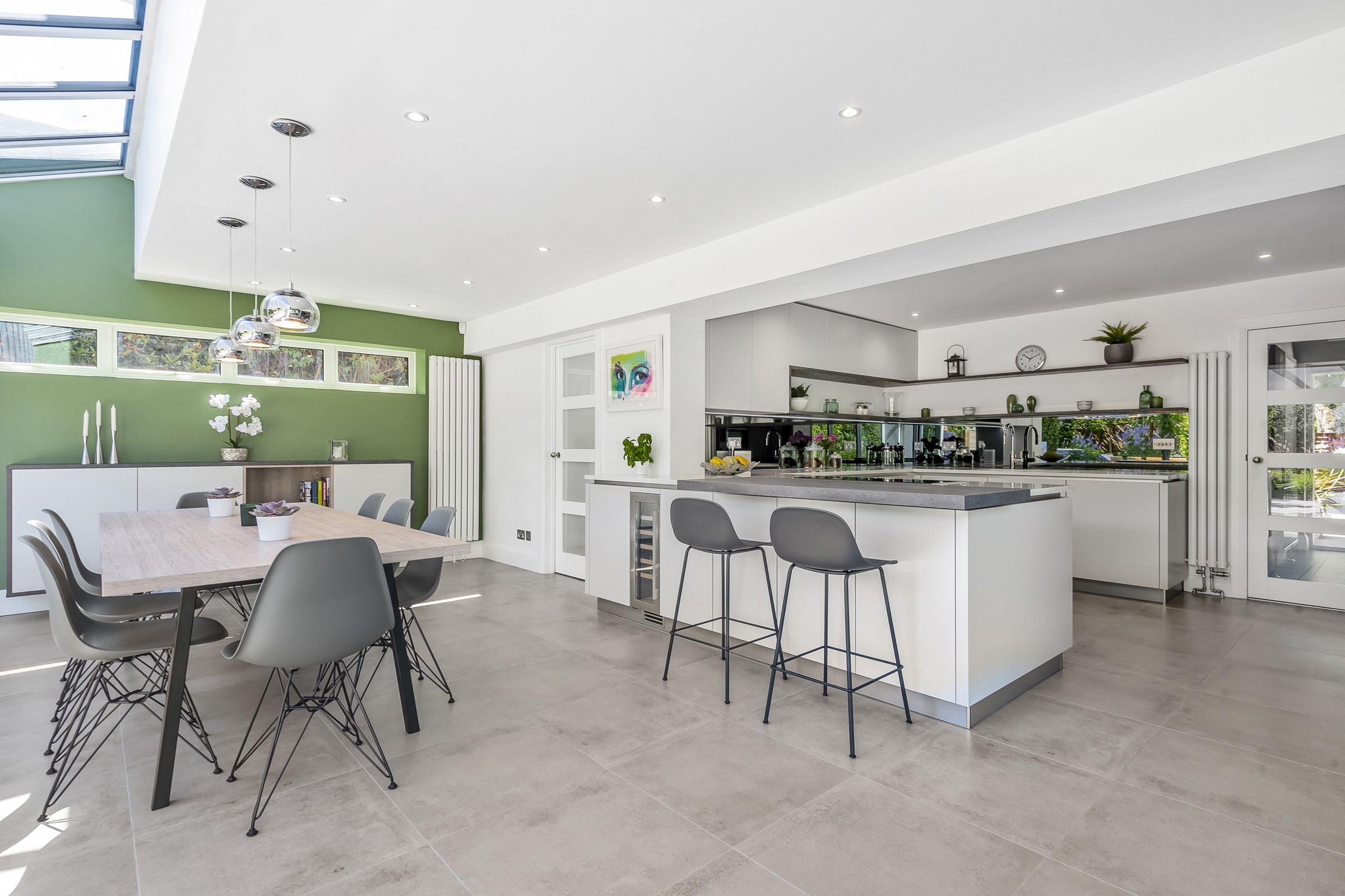 white modern kitchen with peninsula island and dining area