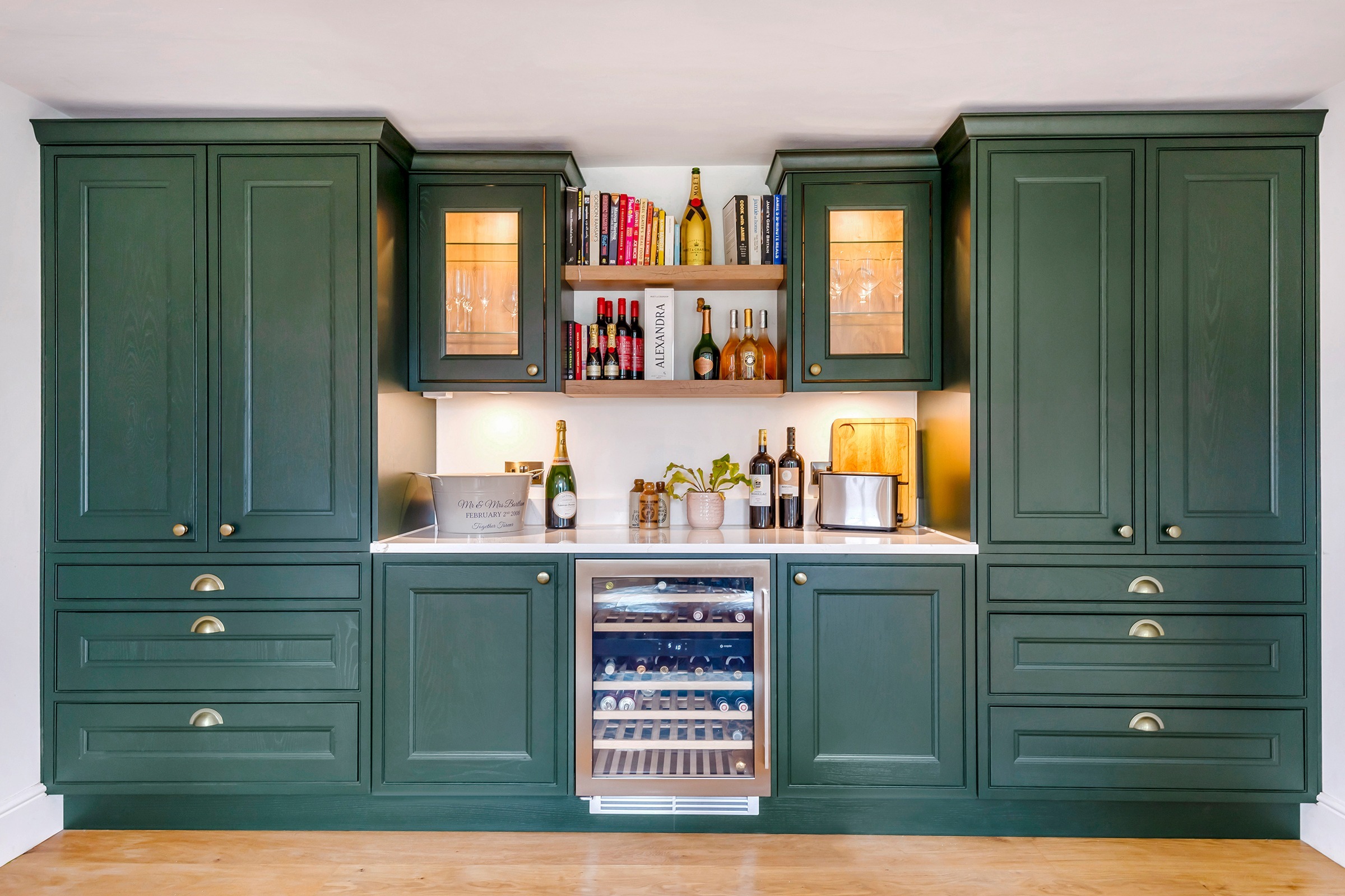 green shaker drinks bar with open shelving and wine fridge