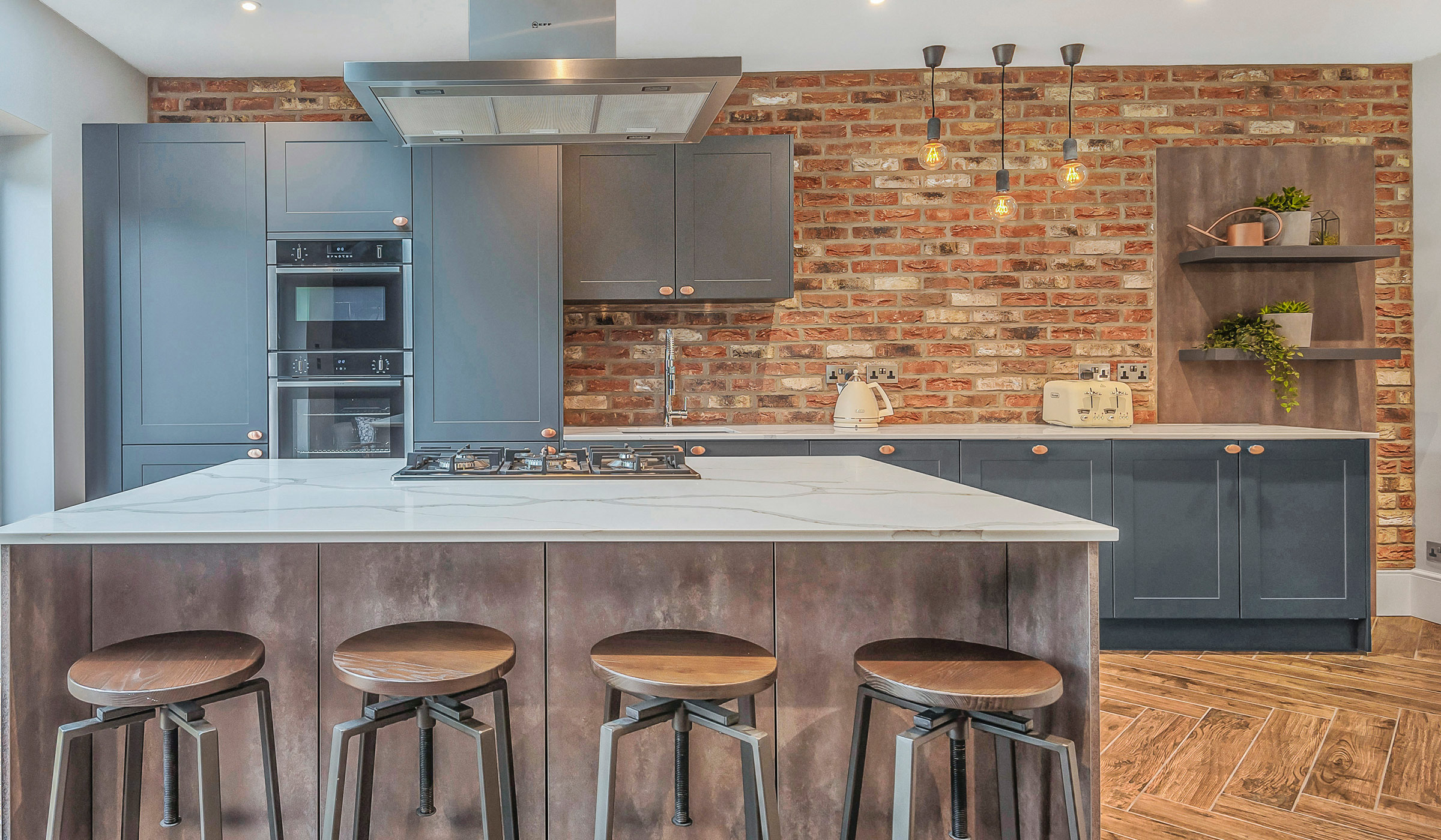 small industrial kitchen with breakfast bar island seating, exposed brick wall and open shelving