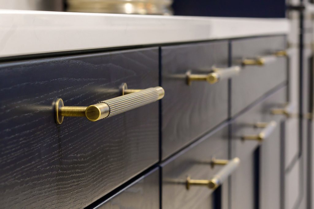 brass fluted lined kitchen handle on blue shaker cabinets