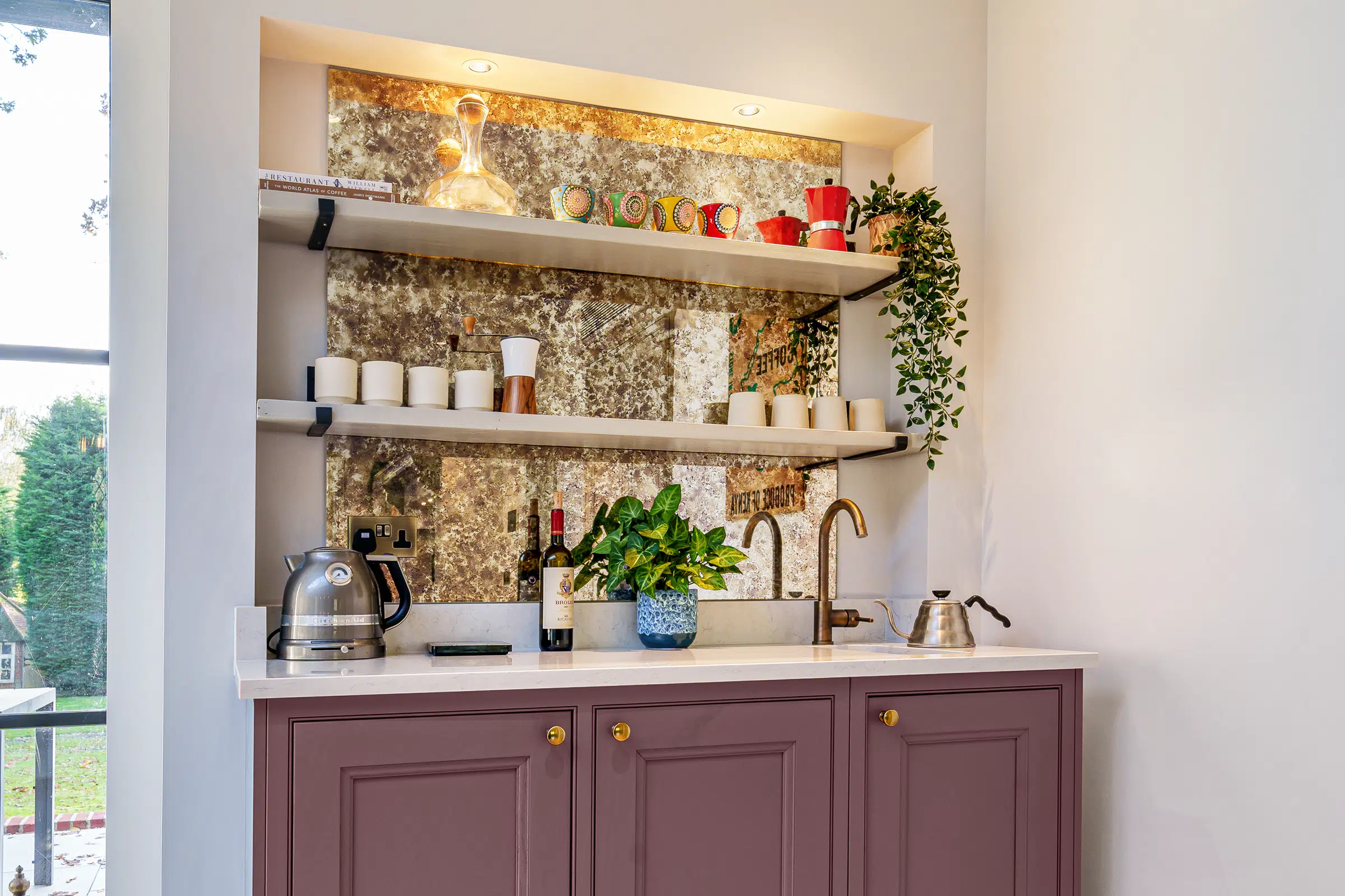 Antique mirror splashback, open-shelving and tea dedicated coffee bar area.