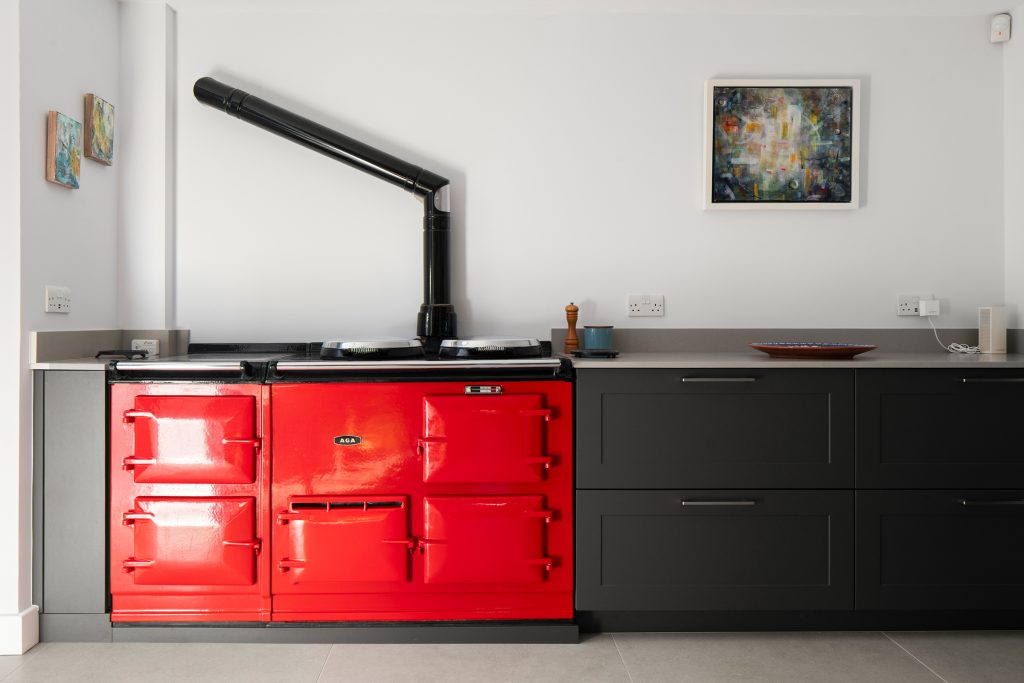 A primary red Aga in a KCA kitchen