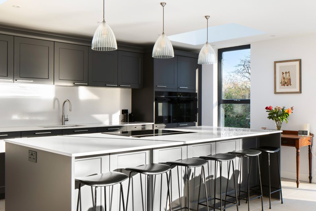 Graphite shaker kitchen with island cooking, pendant lighting and open-plan layout.