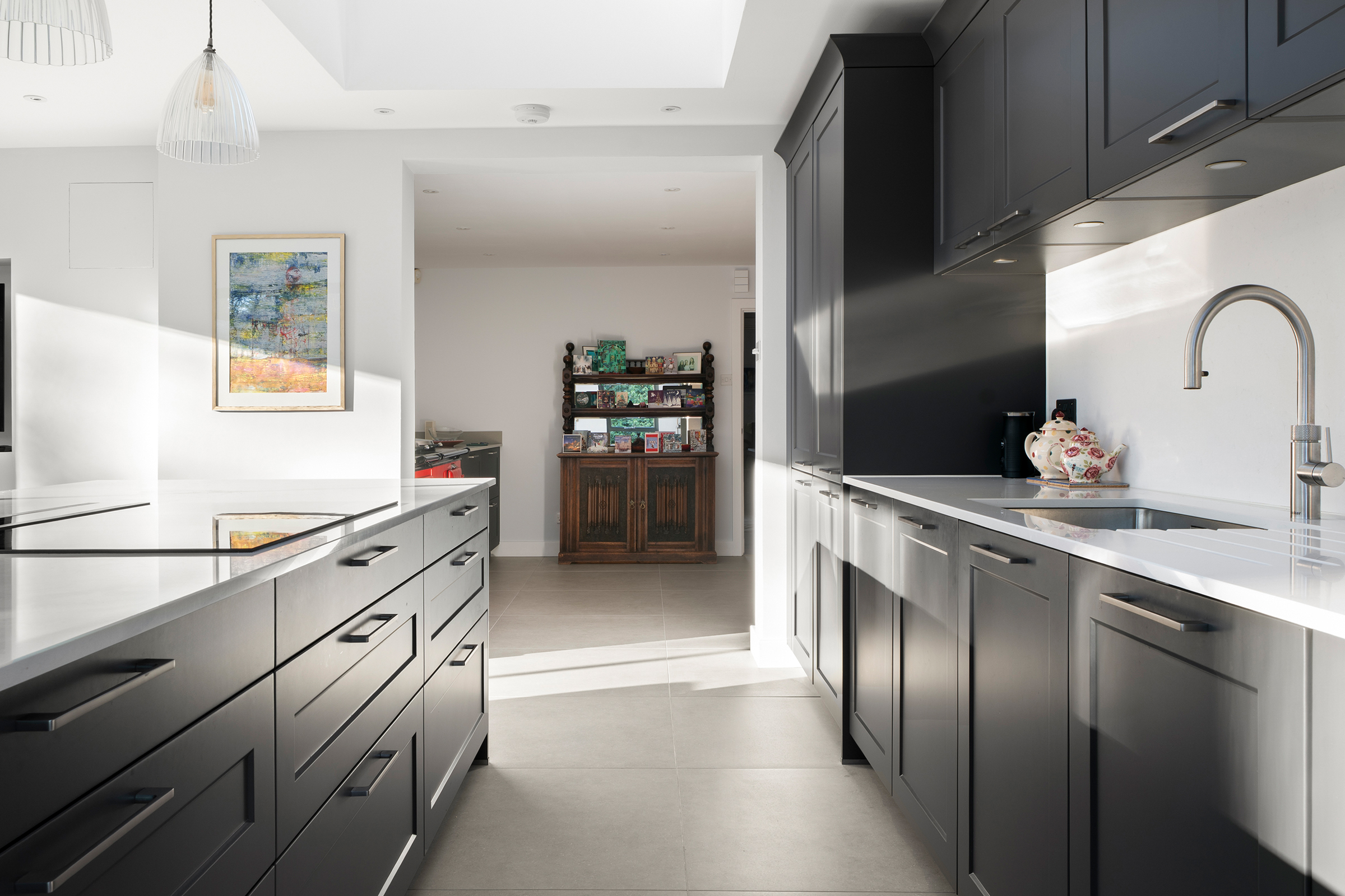 Contemporary shaker kitchen designed to connect a new extension with the original Aga space in an Ascot family home.