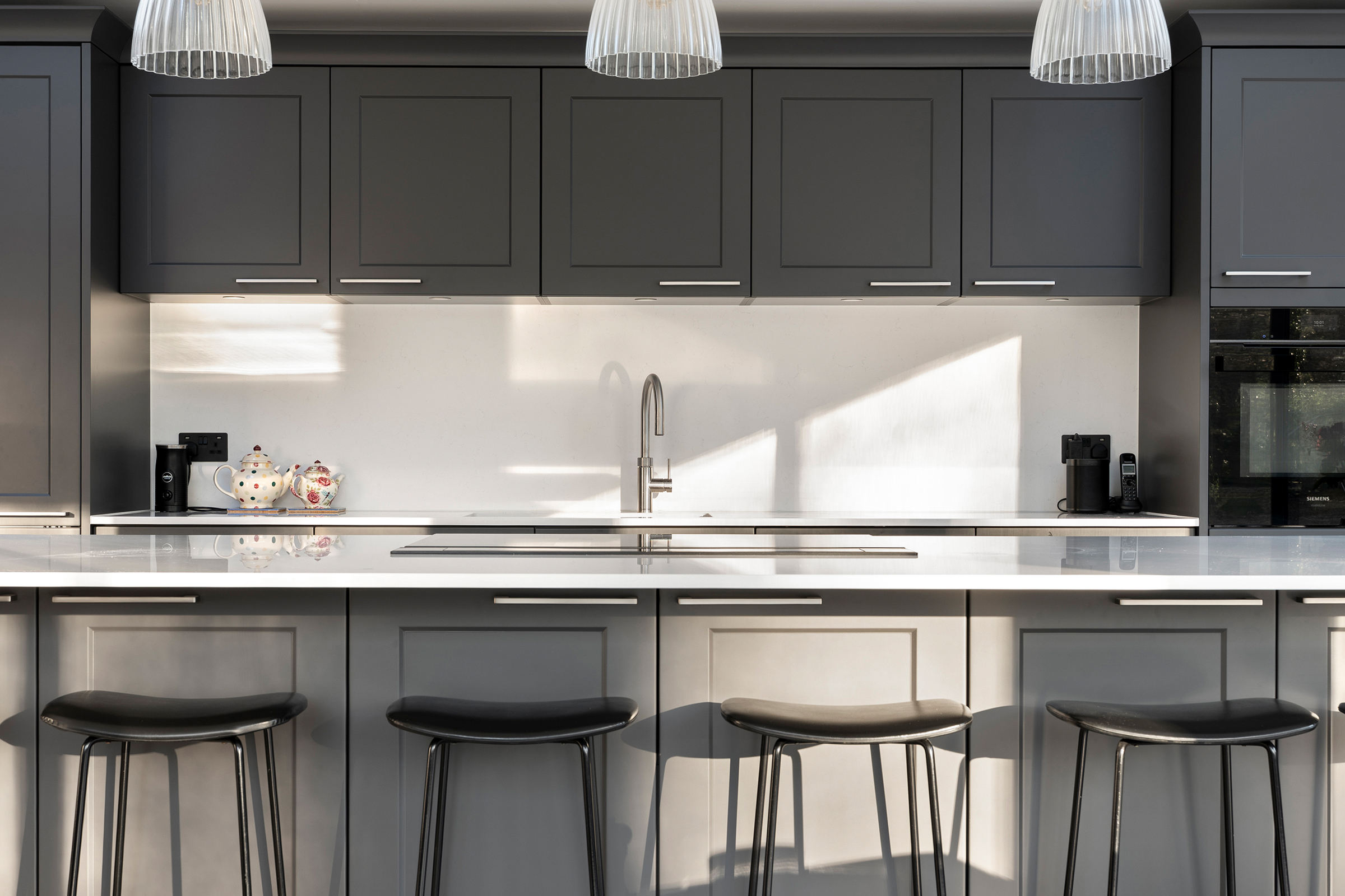 Shaker kitchen island with induction hob and discreet downdraft extraction.