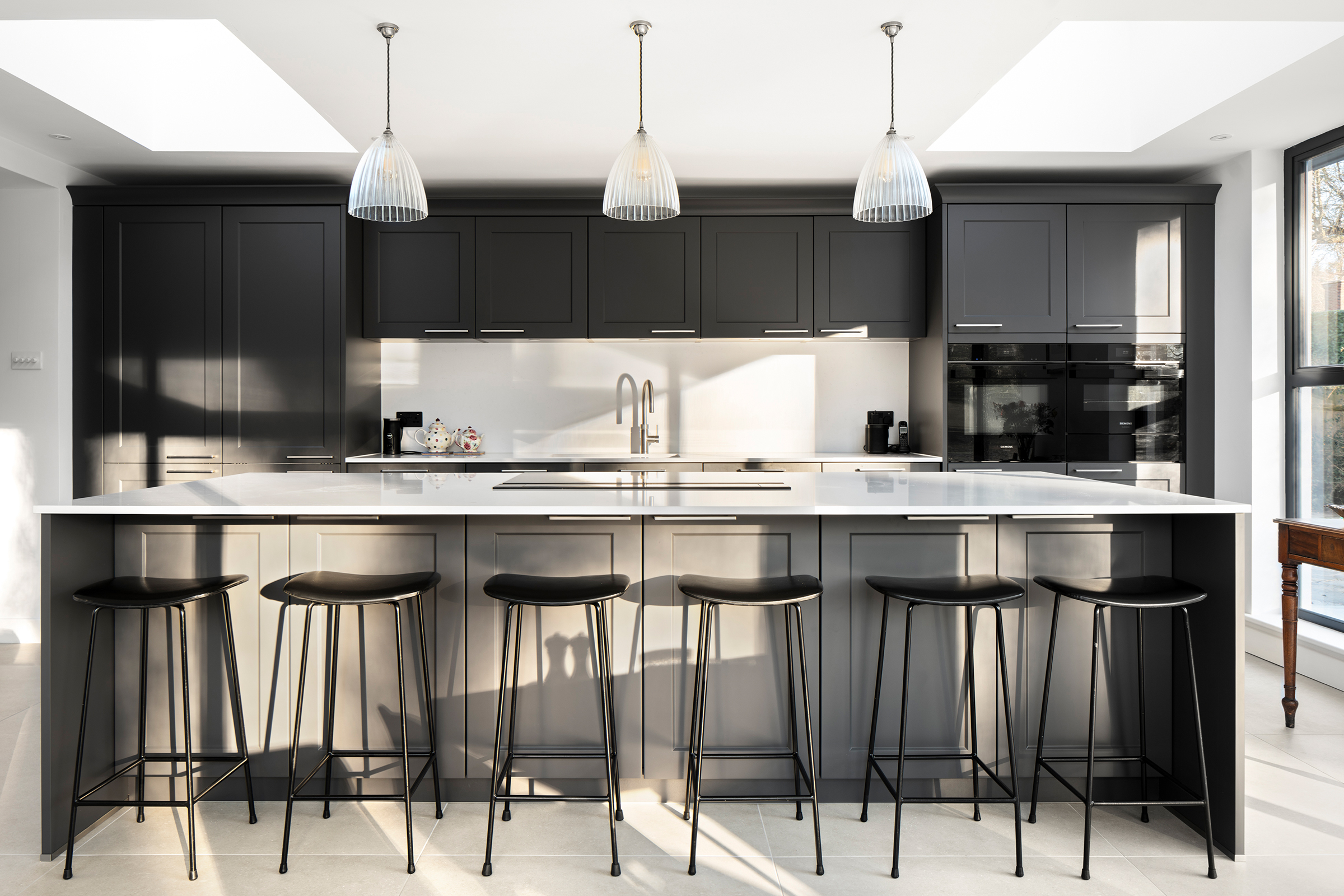 Shaker kitchen island with rear cabinetry designed for additional storage and everyday use.