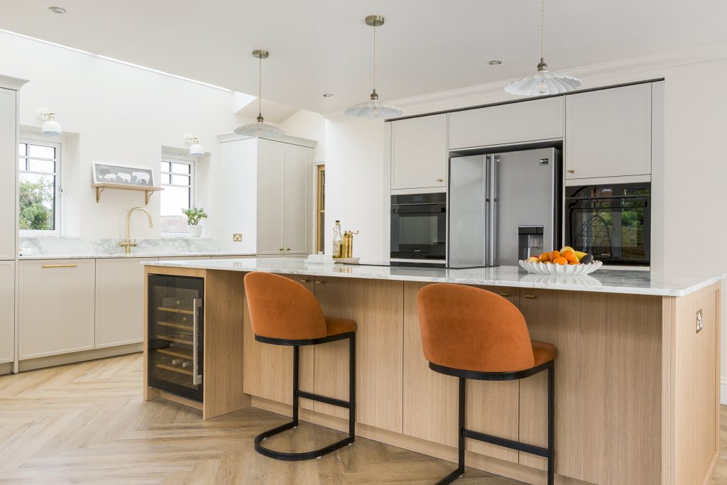 A warm two tone modern kitchen with warm textured furniture.