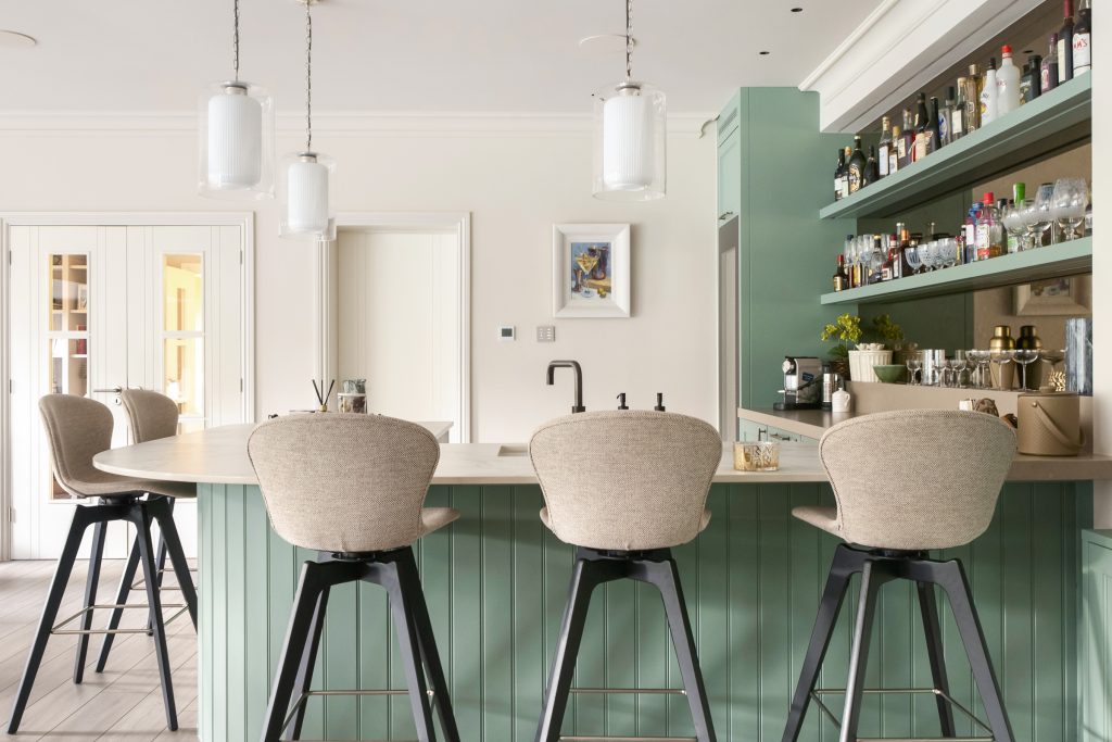 Curved home bar with tongue and groove detailing by KCA kitchens.