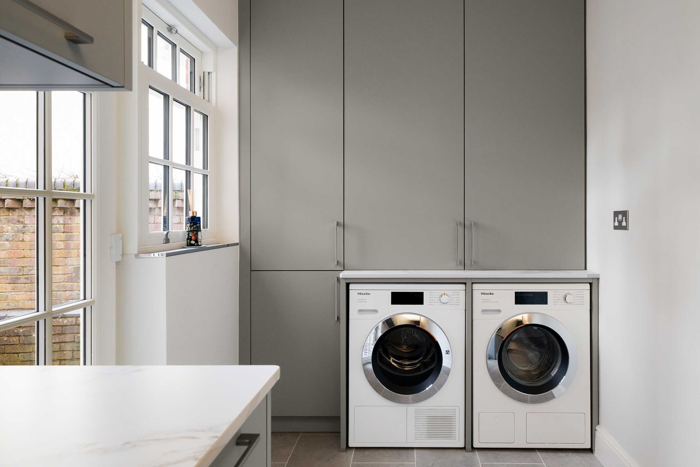 Modern utility room with Miele appliances by Kitchen Connections of Ascot.