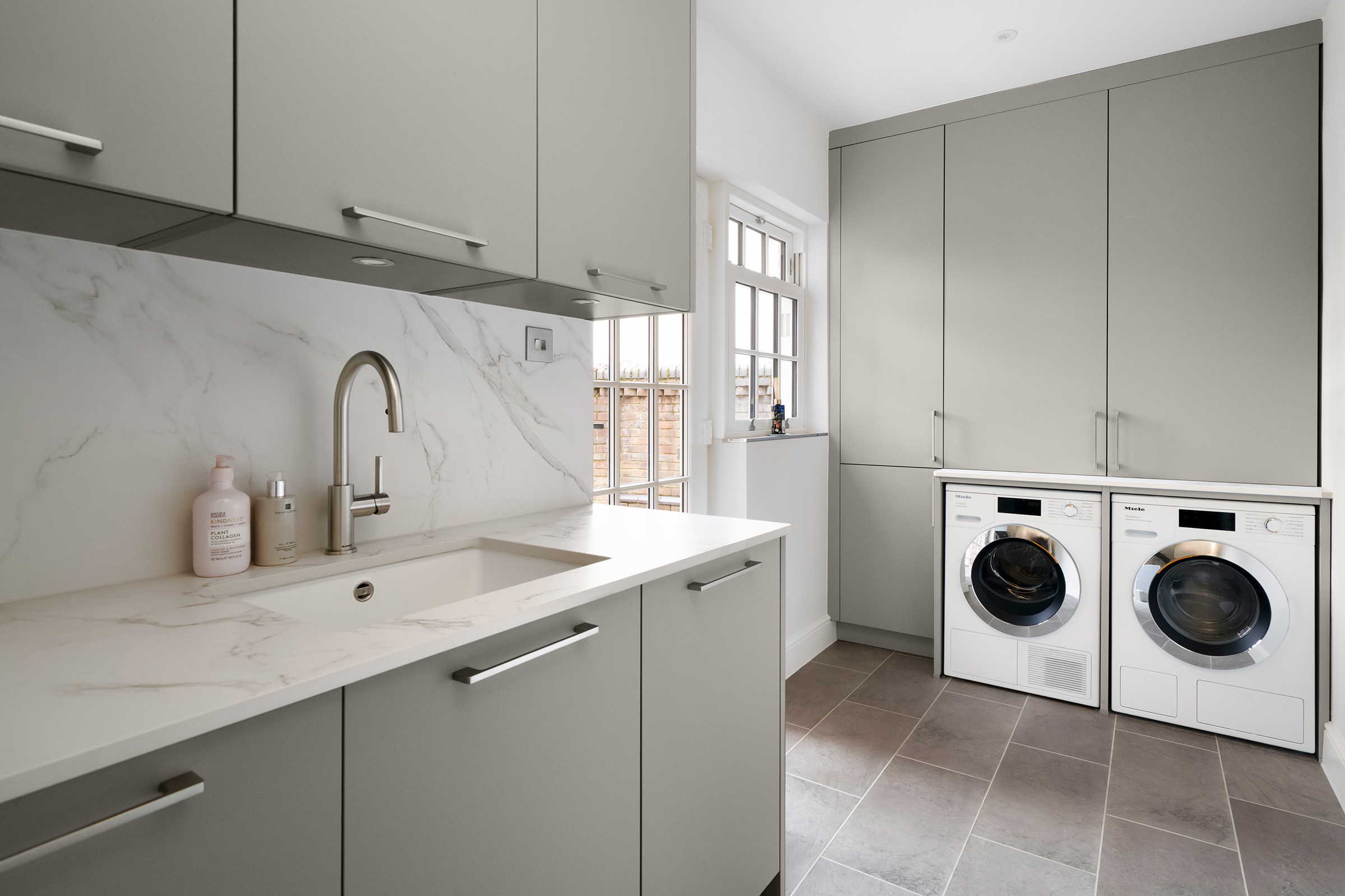 Utility room featuring Hacker flat panel cabinetry by KCA kitchens.