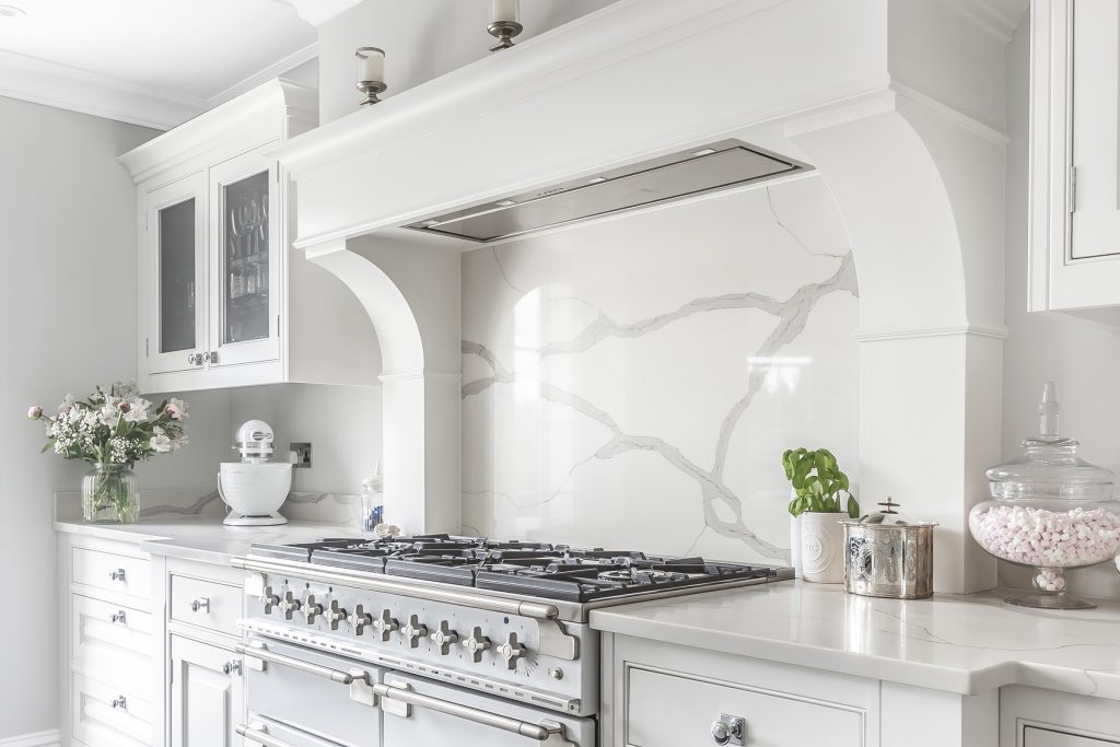 Luxury Davonport shaker kitchen with marble splashback , detailed handcrafted mantel and range cooker.