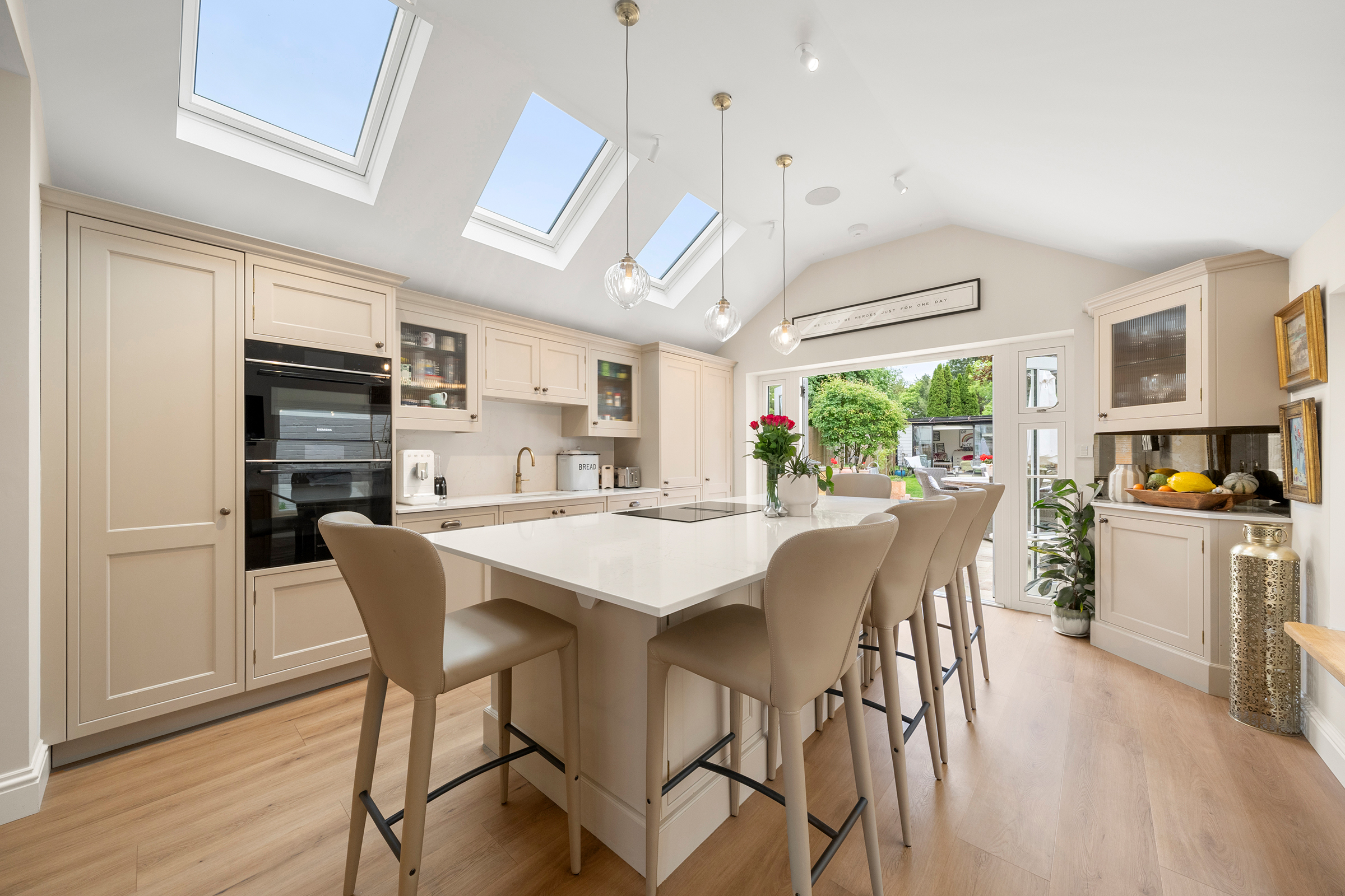 Shaker kitchen island with wraparound seating and bar area in Holyport, Berkshire