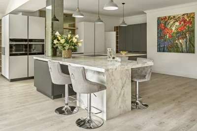An architectural kitchen island with a stone pillar.