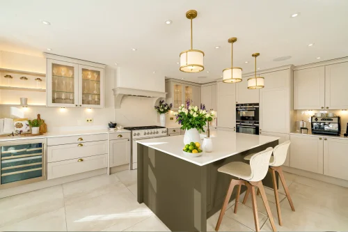 Classic shaker kitchen with hand-painted cabinetry, stone worktops and brass detailing, reflecting heritage kitchen trends for 2026